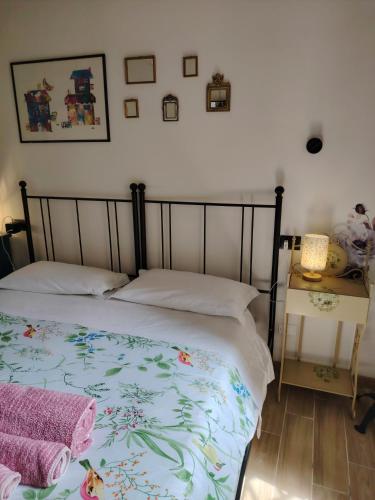 a bedroom with a bed with a floral bedspread on it at Dolce Dimora Siena in Siena