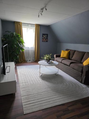 a living room with a couch and a coffee table at Hyllstofta lägenhet in Klippan