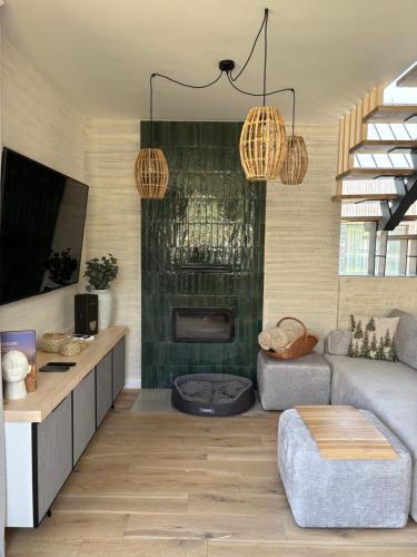 a living room with a couch and a fireplace at Yama Krywe in Krywe