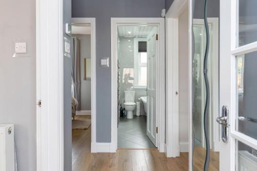 a bathroom with a shower and a toilet in it at Crewe Apartment - Stylish 2 bedroom apt, Garden, Free parking, Edin City in Edinburgh