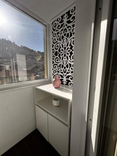 a room with a window and a vase on a dresser at Heaven on earth in Devin