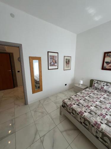 a bedroom with a bed and a mirror on the wall at Little House in Pavia