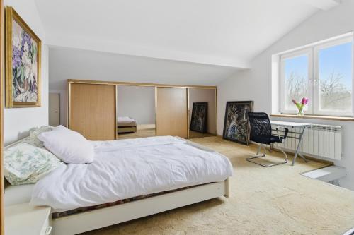 a bedroom with a bed and a desk in it at między Bugiem a Liwcem in Skuszew