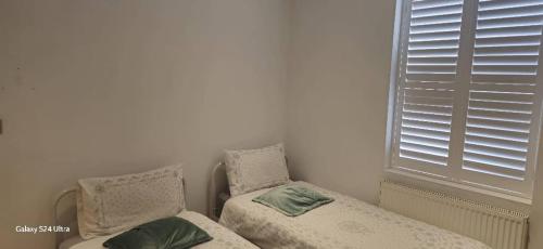 a bedroom with two twin beds and a window at Beautiful Residential Within Easy Reach of Town in Haydock