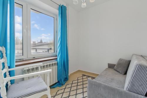 a living room with a couch and a window at między Bugiem a Liwcem in Skuszew