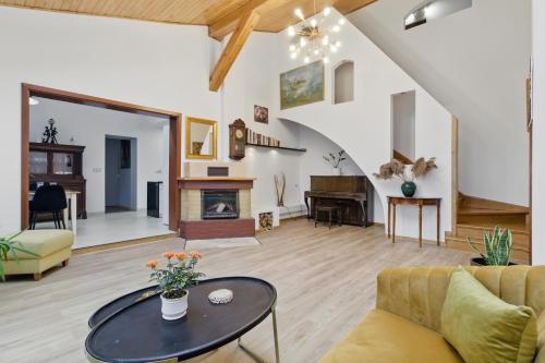 a living room with a couch and a table at między Bugiem a Liwcem in Skuszew