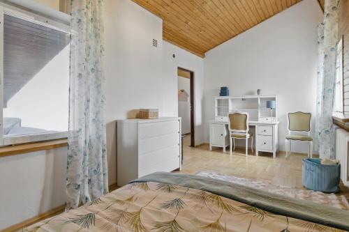 a bedroom with a bed and a desk at między Bugiem a Liwcem in Skuszew