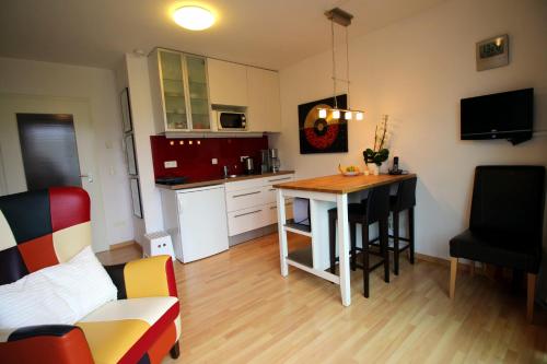 a small kitchen with a table in a room at Studio A Am Burgberg in Erlangen