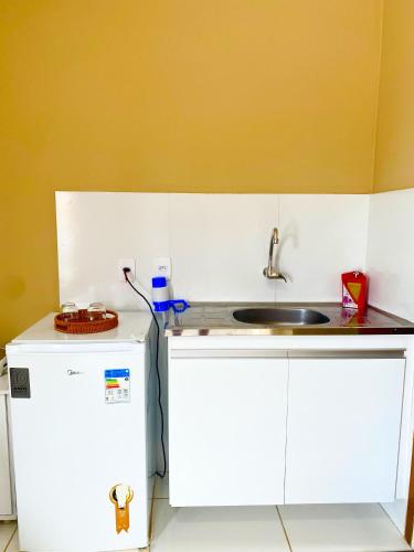 a kitchen with a sink and a white refrigerator at Ap Harmonia Bg in Barra Grande