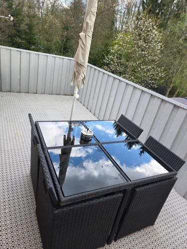 an umbrella sitting on a table on a patio at Hyllstofta lägenhet in Klippan