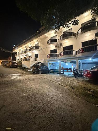 a building with cars parked in front of it at night at Teresek View Motel in Kuala Tahan