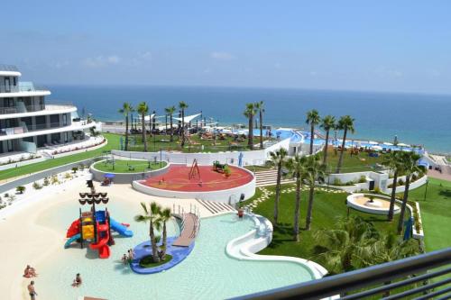 a resort with a water park with a roller coaster at INFINITY View Amazing Beachfront Apartment in Arenales del Sol