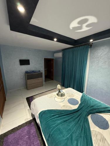 a room with a bed with a table in it at Ara Villa in Marrakech
