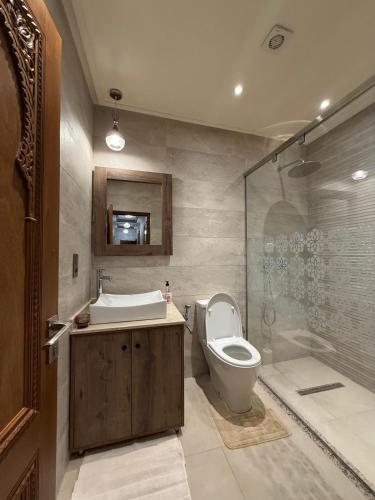 a bathroom with a toilet and a sink and a shower at Ara Villa in Marrakech