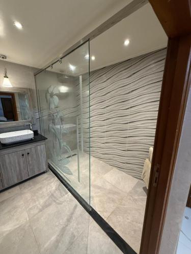a bathroom with a shower with a glass wall at Ara Villa in Marrakech