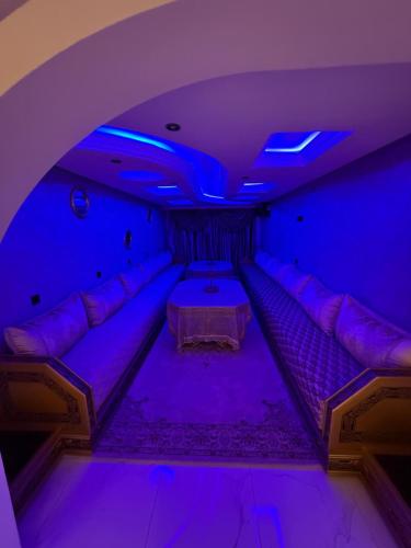 a purple room with a couch and a table at Ara Villa in Marrakech