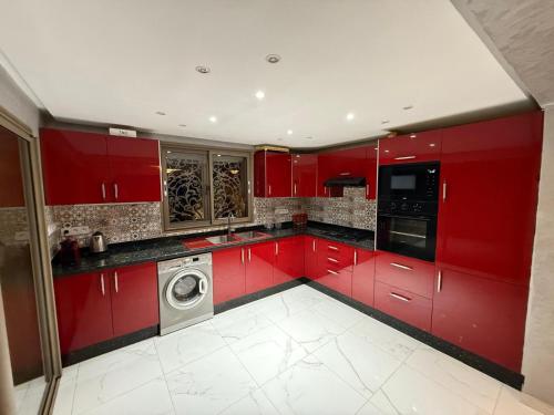 a red kitchen with a washing machine in it at Ara Villa in Marrakech