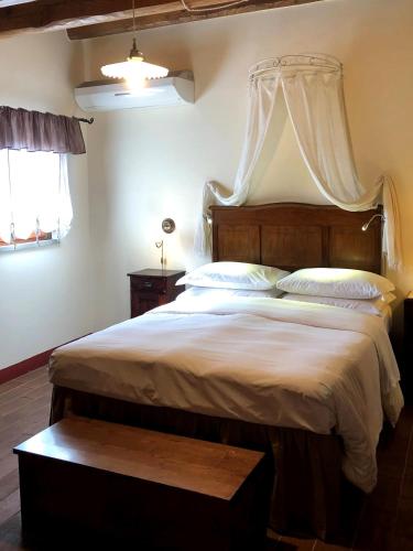 a bedroom with a large bed with a canopy at B&B Hotel La Piana in Borgo a Buggiano