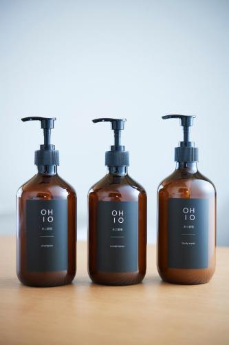 three bottles of soap on a wooden table at OHIO Motosan Shukuba in Takasaki