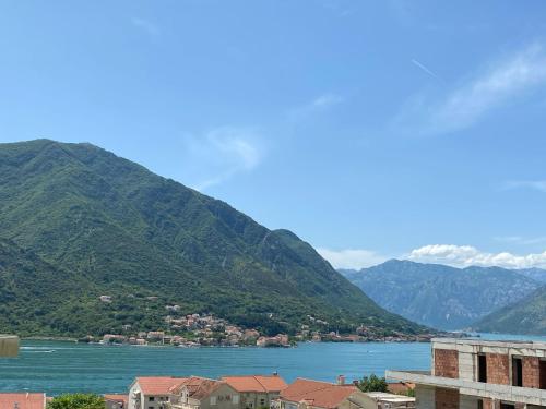 a view of a city and a river with mountains at Belvedere in Dobrota