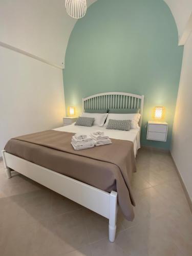 a bedroom with a bed with two towels on it at Nunuccio - Locazione Turistica in Polignano a Mare