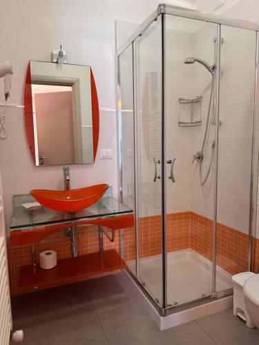 a bathroom with a red sink and a shower at la bussola gallipoli in Gallipoli