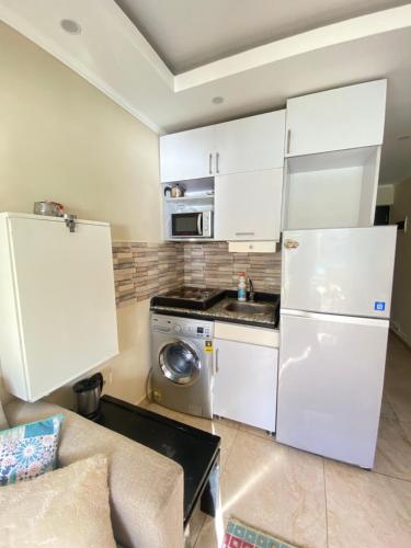 a kitchen with white cabinets and a washer and dryer at Apartment in El Alamein,Sia Lagoon,Golf porto marina in El Alamein
