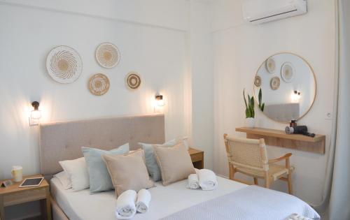a bedroom with a bed with towels on it at Venetia in Tsoútsouros