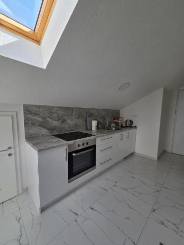 a kitchen with a stove and a counter top at Sarajevo Pulse Residence in Sarajevo