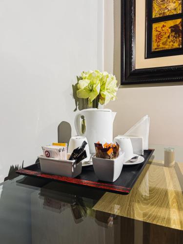 a tray of food on a table with a vase at Hotel VDN by Good Rade in Dakar
