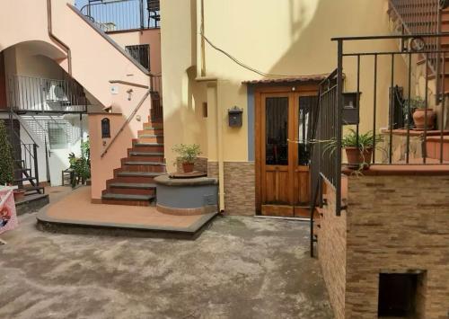 a house with a staircase and a wooden door at casa anna in Vico Equense
