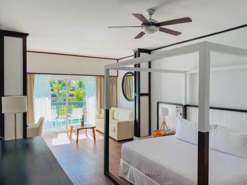 a bedroom with a bed and a ceiling fan at Ocean Blue & Sand Beach Resort - All Inclusive in Punta Cana