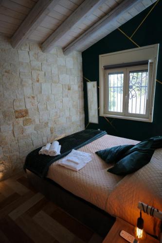 a bedroom with a bed and a window at White House R&B in Campobello di Licata