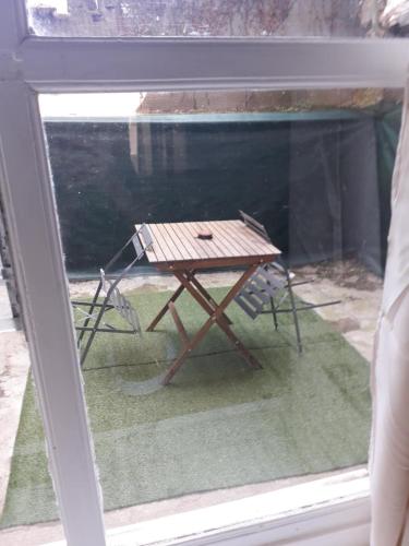 a picnic table sitting inside of a window at Appartement agreable Hugo 1 in Saint-Léonard-de-Noblat