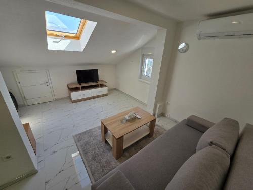 a living room with a couch and a table at Sarajevo Pulse Residence in Sarajevo