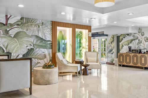a lobby with chairs and a mural of plants at Hotel Ocean in Miami Beach