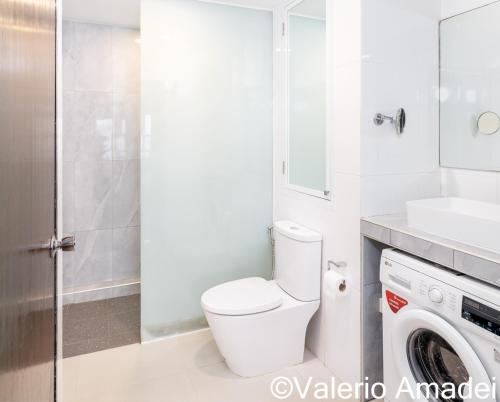 a bathroom with a toilet and a washing machine at Patong Tower Amazing Sea View 12 by PHR in Patong Beach