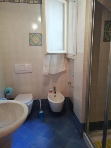 a bathroom with a sink and a toilet and a shower at La grande terrazza di Capo d'Arco in Capo D'Arco