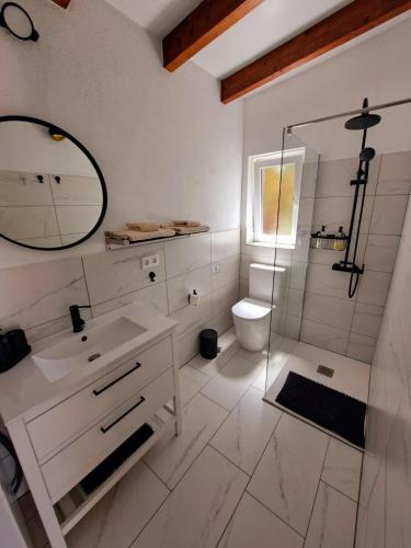 a bathroom with a glass shower and a toilet at Casa Nogal in Puntagorda