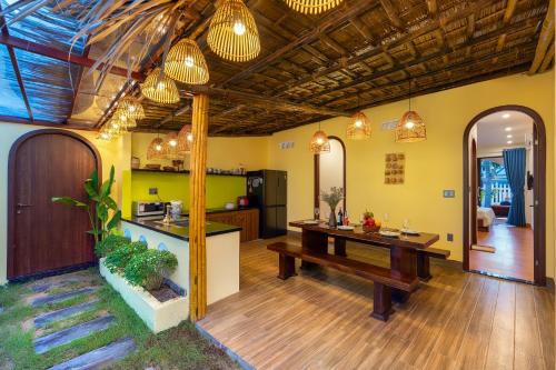 a kitchen and living room with a table and a counter at Dan Linh Homestay in An Bang