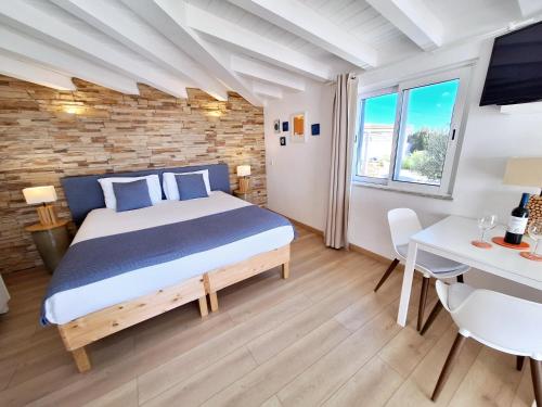 a bedroom with a king sized bed and a desk at Romantik Villa in Salema