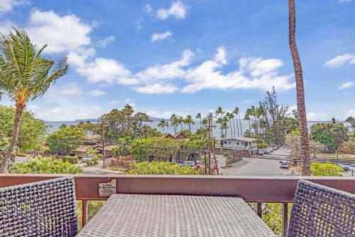 a table on a balcony with a view of a street at Maui Vista 1411 in Kihei