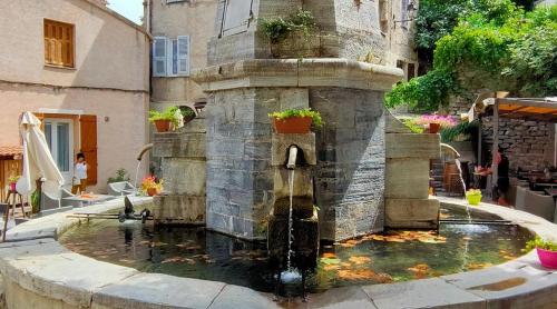une fontaine au milieu d'une ville dans l'établissement Charmant Type 2 hyper centre, à Corte
