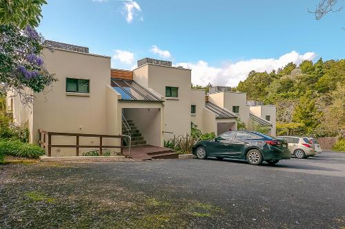 a green car parked in front of a house at Paihia Pacific Resort Hotel in Paihia