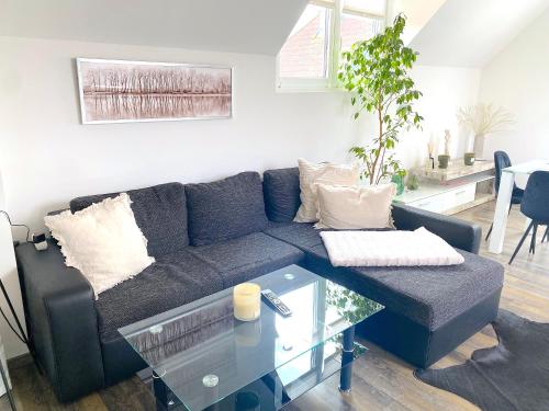 a living room with a blue couch and a glass table at ferien-wohnen in Mautern