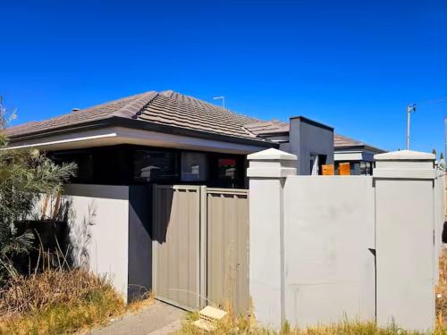 a house with a gate and a fence at Quiet house in Bedford in Perth