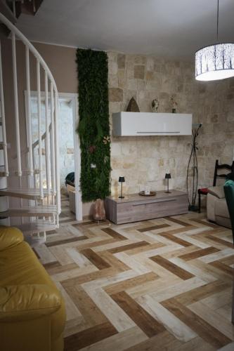 a living room with a couch and a floor at White House R&B in Campobello di Licata