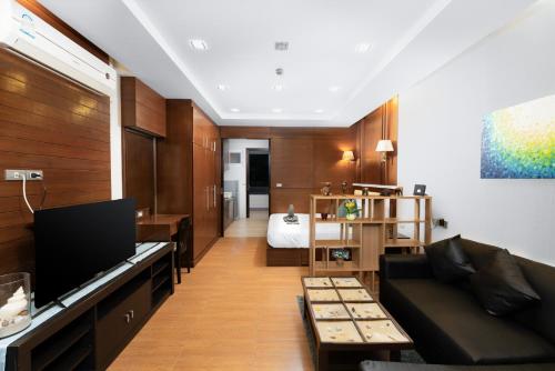a living room with a couch and a bed at Sea & Sky Karon Beach by PHR in Karon Beach