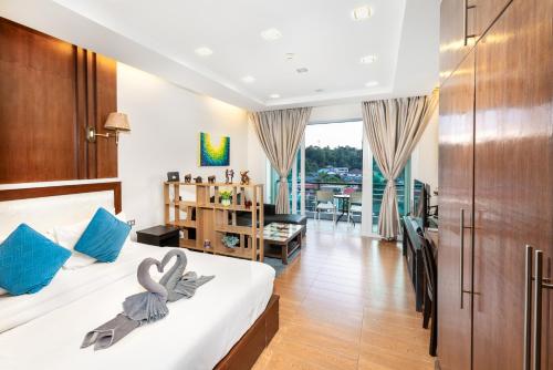 a bedroom with a bed with swans towels on it at Sea & Sky Karon Beach by PHR in Karon Beach