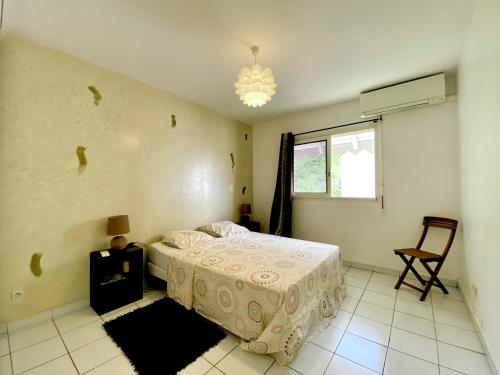 a bedroom with a bed and a window at Mayani in Gourbeyre
